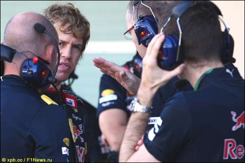 Себастьян Феттель обсуждает с инженерами причину прокола